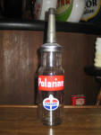 Standard Oil Company Polarine 1 quart oil bottle, comes with pictured spout and cap.  $275.00.  